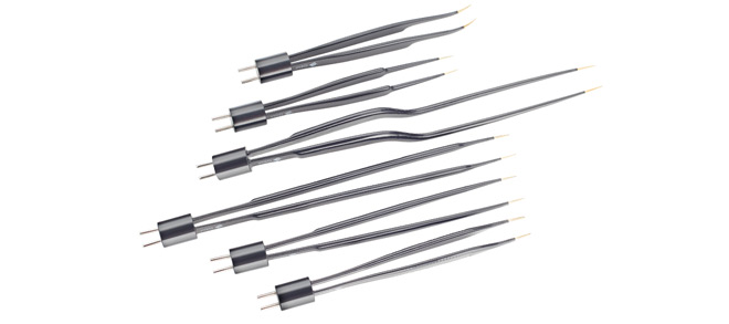 Seven black two-pronged electrode pins arranged in a row on a white background.