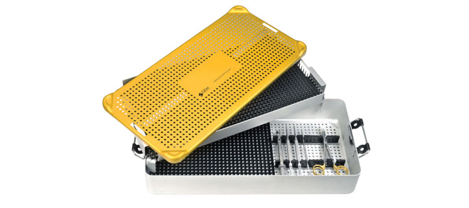 Perforated yellow lid on a metal container with various surgical instruments inside.